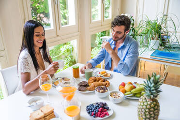 Glückliches Paar beim gesunden Frühstück zu Hause am Morgen - Glückliche Momente der häuslichen Partnerschaft - DMDF00886