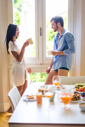 Happy couple having healthy breakfast at home in the morning - Happy moments of domestic partnership - DMDF00899
