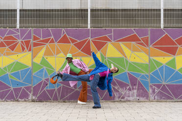 Couple dancing in front of colorful wall - AFVF09327