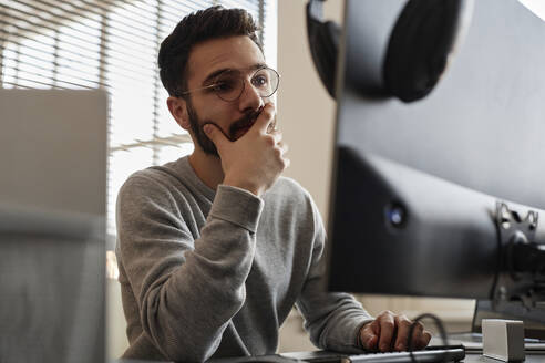 Aufmerksamer IT-Fachmann, der am Computer arbeitet - KPEF00094