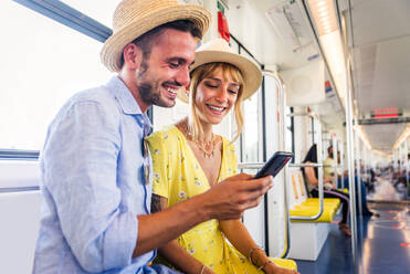 Beautiful couple driving on a subway wagon, concepts about lifestyle and trasportation - DMDF01319