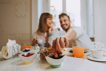 Two young adults at home - Beautiful couple of lovers having breakfast in the morning - DMDF01369