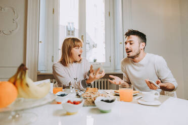 Two young adults at home - Beautiful couple of lovers having a discussion about betrayal - DMDF01374