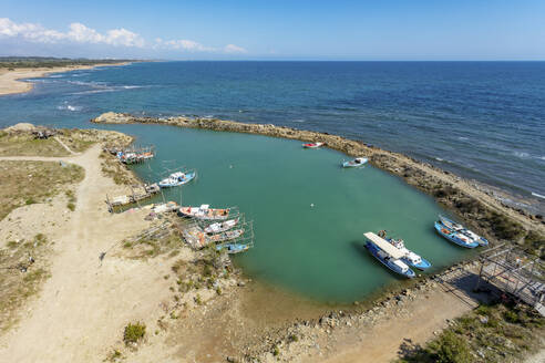 Aerial view of small manmade primitive fishing port on the Mediterranean Sea coast of Belek, Antalya, Turkey. - AAEF19479