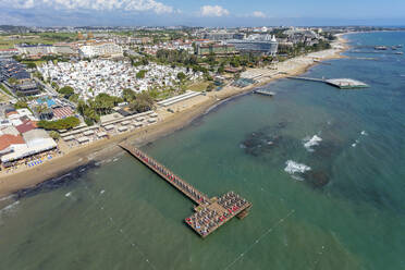 Aerial view of hotels, piers and beach in the Mediterranean Sea coast of Side, Antalya, Turkey. - AAEF19481