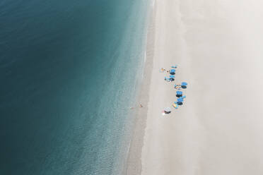 Aerial view of people with blue umbrellas in Baia del Tono, Milazzo, Sicily. - AAEF19510