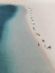 Aerial view of a beach line full of umbrellas, Tindari, Sicily, Italy. - AAEF19524