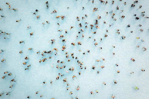 Aerial view of people doing a bath in a huge pool, Sicily, Italy. - AAEF19526