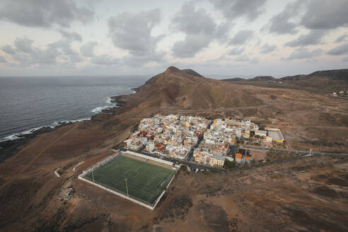 Panoramic aerial view of a soccer pitch and a little town, Las Coloradas, Gran Canaria, Spain. - AAEF19552