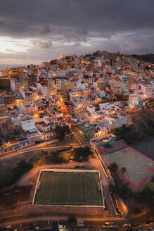 Aerial view of a soccer pitch and houses at night, San Jose, Gran Canaria, Spain. - AAEF19553