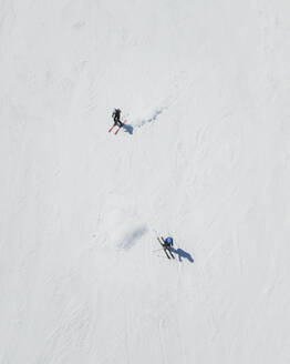 Aerial view of two skiers, Mount etna, Sicily, Italy. - AAEF19590