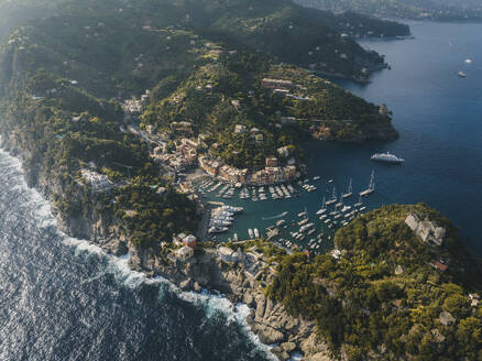 Aerial view of Portofino harbour along the coastline, Liguria, Italy. - AAEF19642