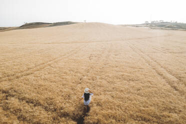 Aerial view of a girl in the sicilian countryside, Sicily. - AAEF19682