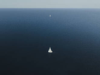 Aerial view of a boat at sunset, Sicily, Italy. - AAEF19761