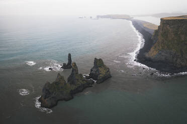 Panoramic aerial view of rocks and a black sand beach, Reynisfjara, Iceland. - AAEF19803