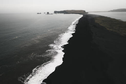 Aerial view of foam on a black sand beach, Reynisfjara, Iceland. - AAEF19807