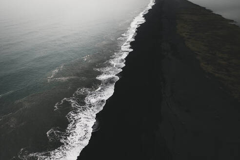 Aerial view of foam on a black sand beach, Reynisfjara, Iceland. - AAEF19809