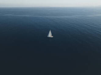 Aerial view of a sailing boat in Tindari bay, Sicily, Italy. - AAEF19829