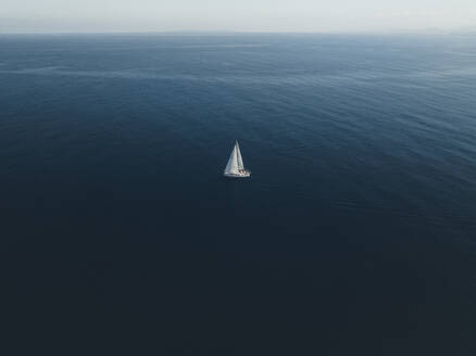 Aerial view of a sailing boat in Tindari bay, Sicily, Italy. - AAEF19829