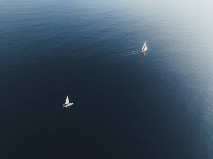 Aerial view of two boats sailing the Mediterranean Sea, Sicily, Italy. - AAEF19843