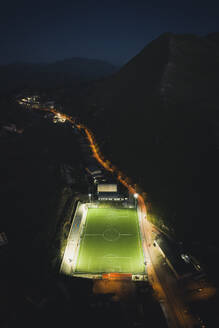 Aerial view of a football pitch at night, Gangi, Sicily, Italy. - AAEF19855