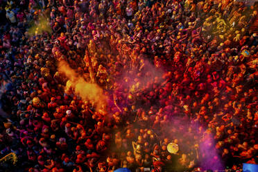 Nandgaon, India - 01 March 2023: Aerial view of people celebrating the holy colour festival at Shri And Baba Temple, Uttar Pradesh, India. - AAEF19907