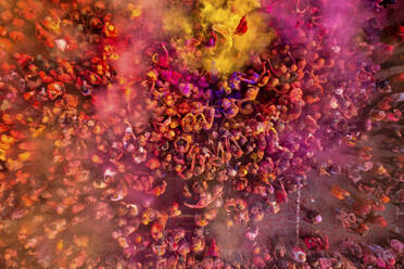 Nandgaon, India - 01 March 2023: Aerial view of people celebrating the holy colour festival at Shri And Baba Temple, Uttar Pradesh, India. - AAEF19908