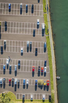 Aerial view of Looe carpark with cars and moored boat, Cornwall, United Kingdom. - AAEF19935