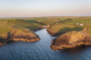 Aerial view of Port Quin during sunset and moonrise, Cornwall, United Kingdom. - AAEF19944