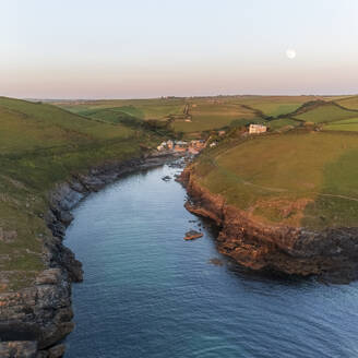 Aerial view of Port Quin during sunset and moonrise, Cornwall, United Kingdom. - AAEF19947