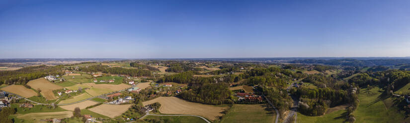 Aerial drone panoramic view of the countryside under an almost clear sky on the border with Styria and Burgenland, Austria. - AAEF20046