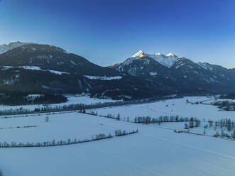 Aerial drone view of Drava Valley covered in snow, Greifenburg, Carinthia, Austria. - AAEF20055