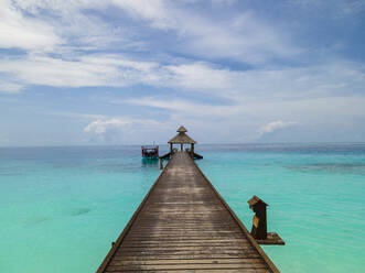 Aerial view of pier and boardwalk on crystal clear blue ocean island, Baa Atoll, Maldives. - AAEF20067