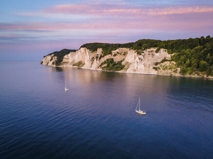 Aerial view of two sailboats mooring close to Mons Klint, Denmark. - AAEF20106