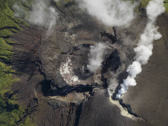 Aerial top down view of smoke coming out of active Gamalama Volcano on Ternate, Indonesia. - AAEF20114