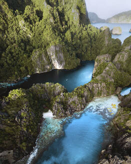 Aerial view of canoe at Big Lagoon on Miniloc Island, El Nido, Palawan, Philippines. - AAEF20184