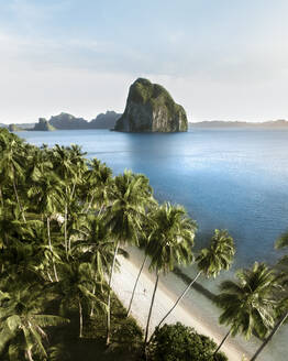 Aerial view of a tropical beach along the coast, Las Cabanas, El Nido, Palawan Philippines. - AAEF20199