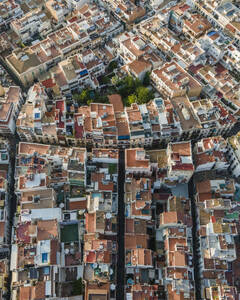 Aerial top down view of Sitges downtown with red rooftops and residential district, Barcelona, Spain. - AAEF20236