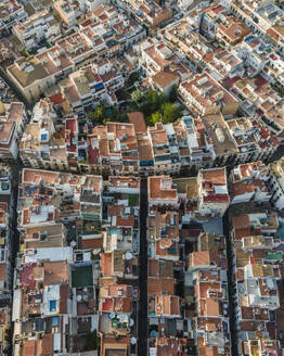 Aerial top down view of Sitges downtown with red rooftops and residential district, Barcelona, Spain. - AAEF20236