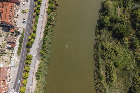 Aerial view of a person with a kayak paddling along the Tagus river in Talavera de la Reina, Toledo district, Spain. - AAEF20260