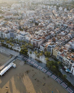 Aerial view of Sitges downtown with a long promenade along the Mediterranean Sea coastline, Barcelona, Spain. - AAEF20273
