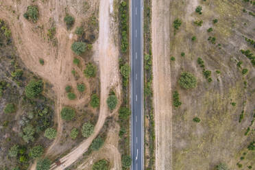 Aerial view of a road crossing the countryside along the Spanish and Portuguese border, Zebreira, Castel Branco, Portugal. - AAEF20297