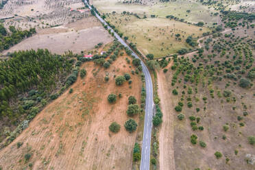 Aerial view of a road crossing the countryside along the Spanish and Portuguese border, Zebreira, Castel Branco, Portugal. - AAEF20299