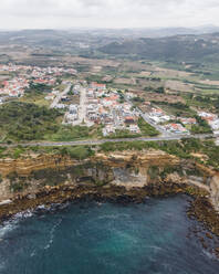 Aerial view of Sao Lourenco, a small town on the cliffs along the Atlantic Ocean coastline, Lisbon, Portugal. - AAEF20359