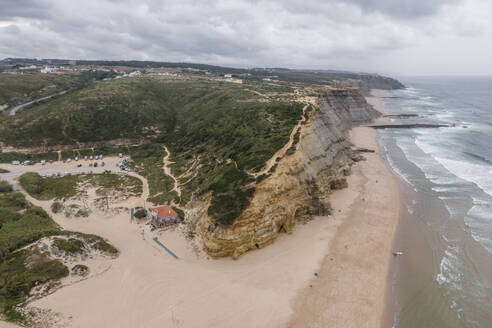 Aerial view of Sao Juliao beach with high cliffs and beautiful beach along the Atlantic Ocean coastline, Carvoeira, Lisbon, Portugal. - AAEF20365