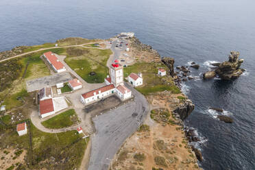 Aerial view of Cabo Carvoeiro lighthouse at sunset along the Atlantic Ocean coastline in Peniche, Leiria, Portugal. - AAEF20380