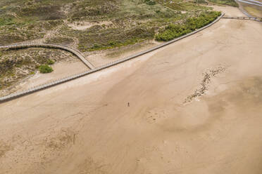 Aerial view of a person on Praia de Salir do Porto beach along Baia de Sao Martinho do Porto, a small bay along the coast in Portugal. - AAEF20433