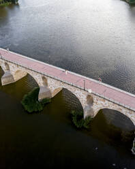 Aerial view of an old stone bridge crossing the Douro river in Zamora, Spain. - AAEF20507