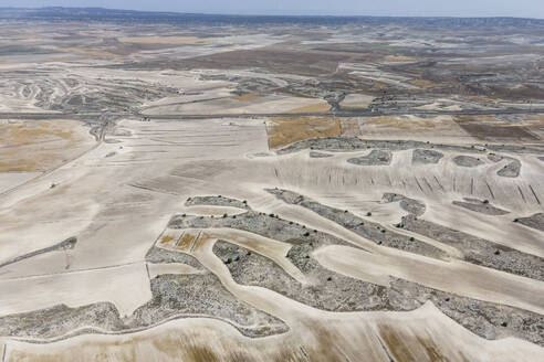 Aerial view of an arid landscape near the Monegros desert, Zaragoza, Spain. - AAEF20543
