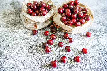 Fresh ripe cherries on a table at springtime, Italy, Europe - RHPLF26098